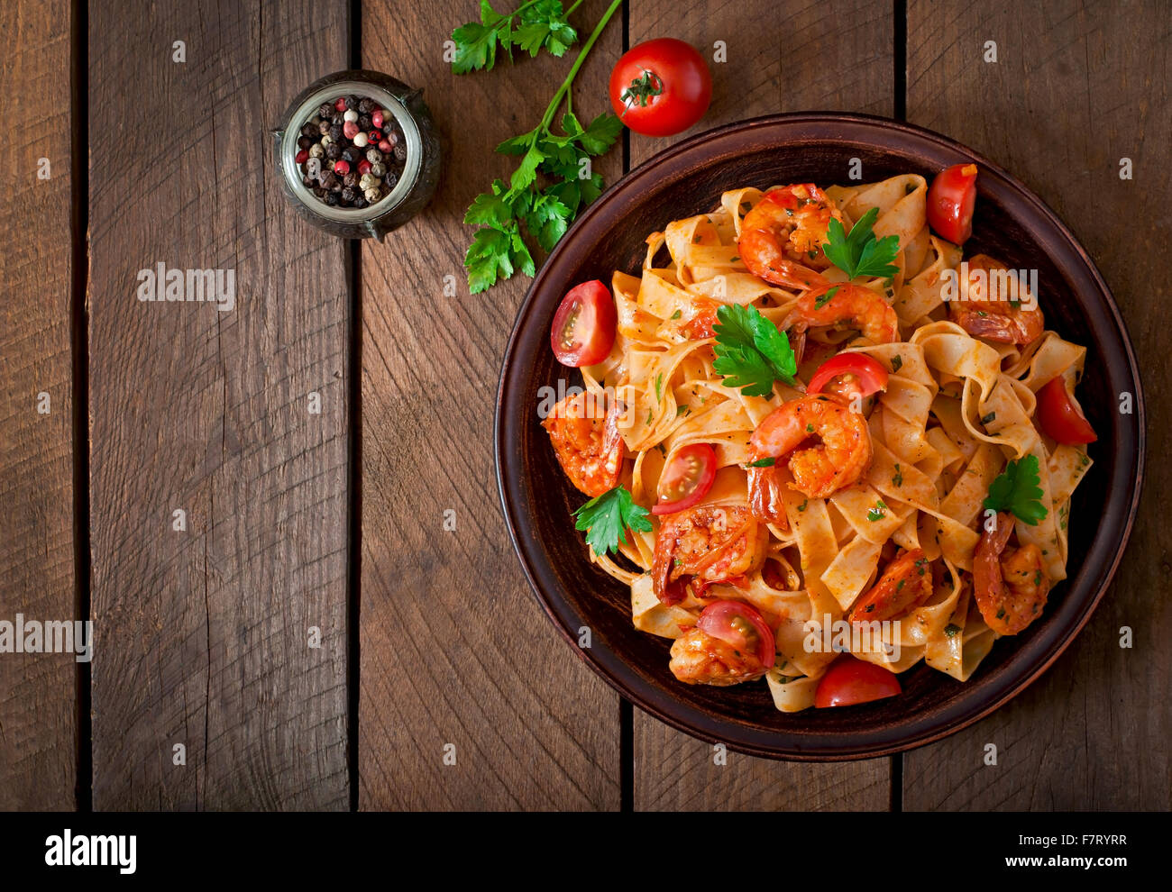 Fettuccine pasta with shrimp, tomatoes and herbs. Top view Stock Photo ...