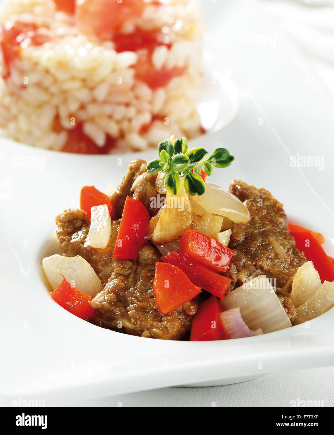 Beef stew with bell pepper and onions. Served with rice Stock Photo Alamy