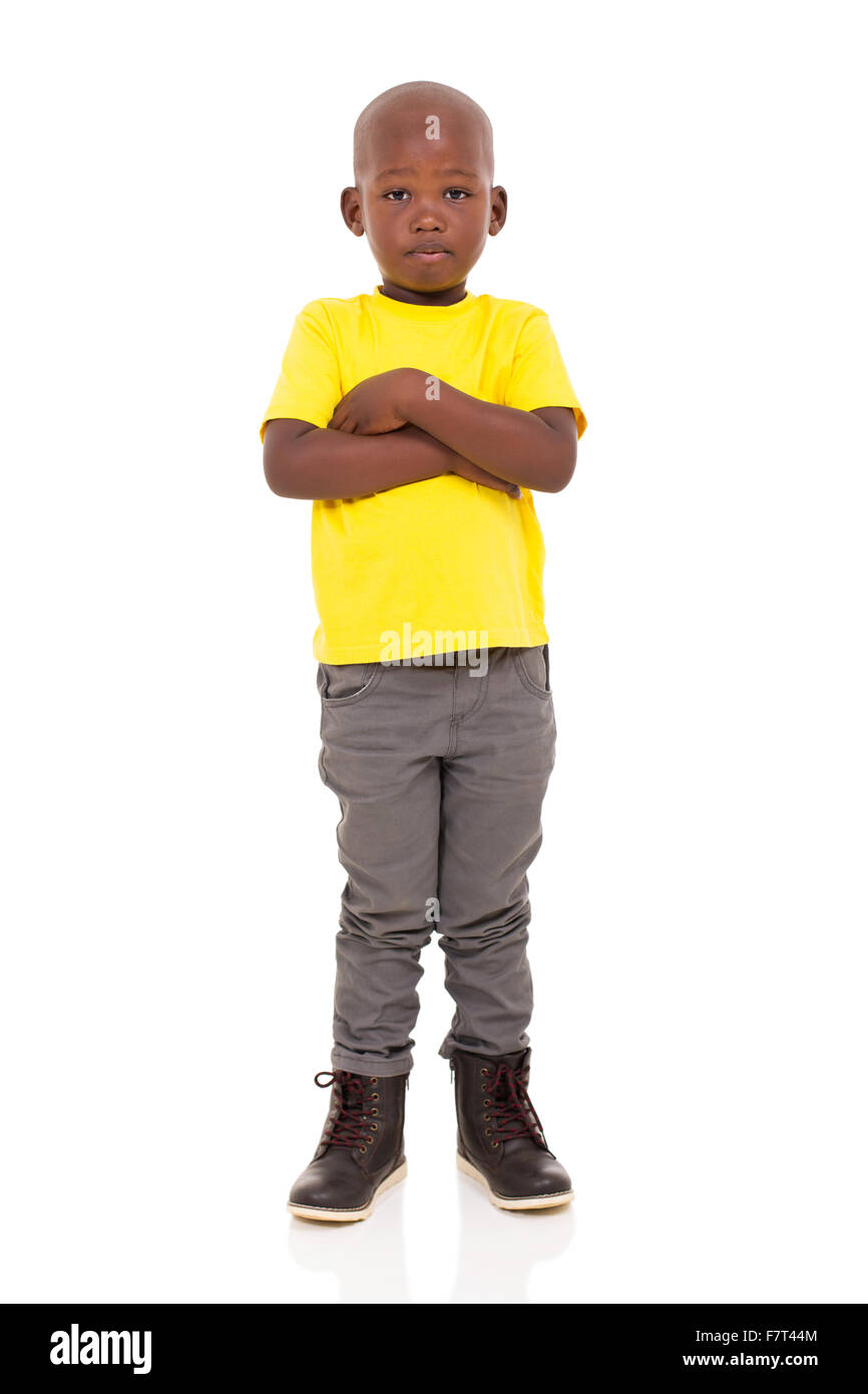 adorable young African boy with arms crossed on white background Stock Photo