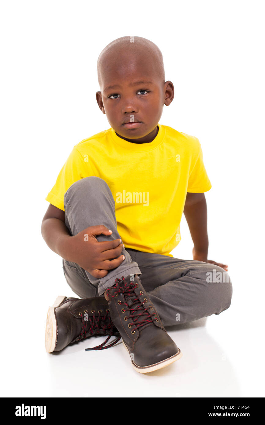 handsome little African boy sitting on floor Stock Photo