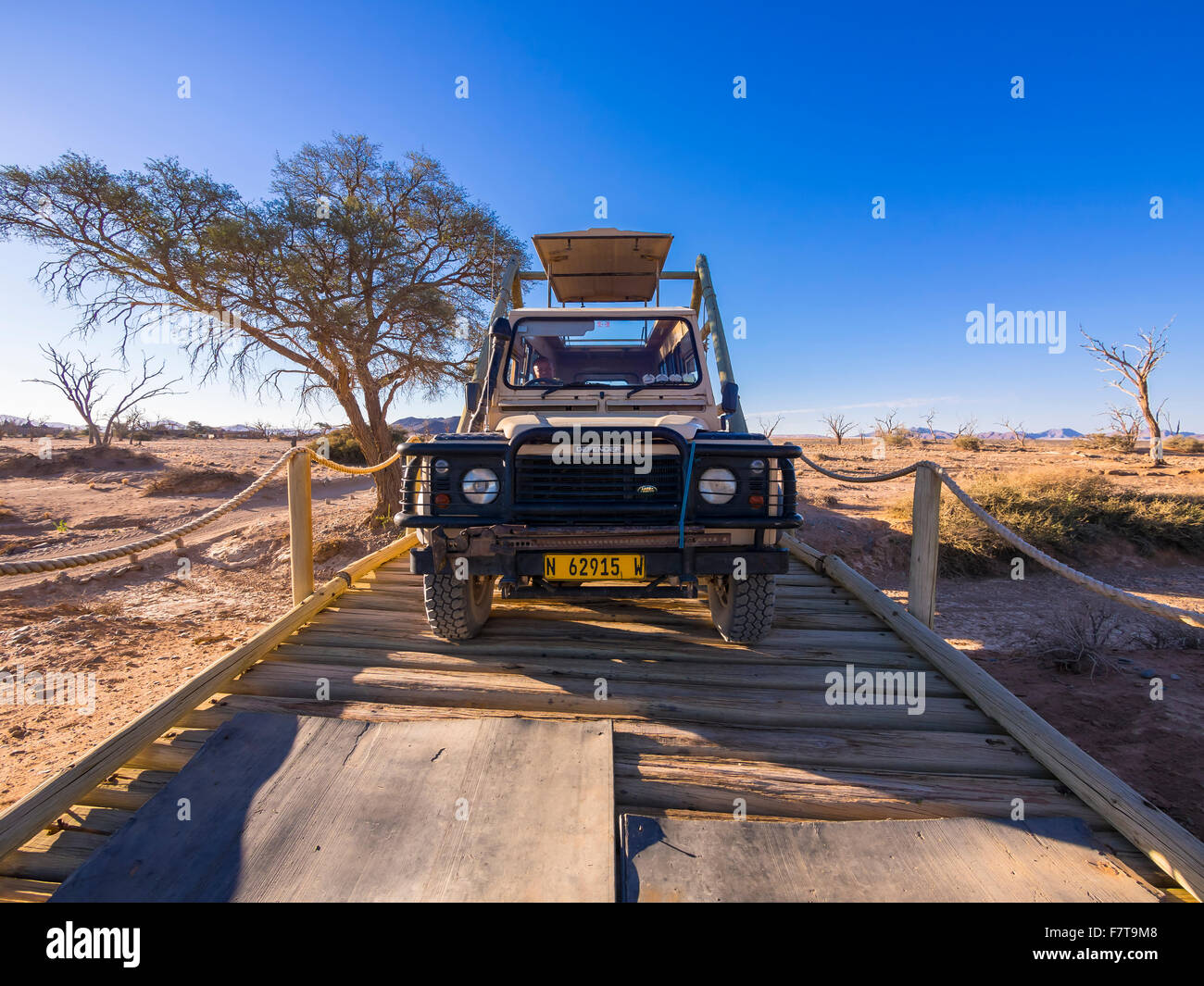 Land Rover crossing a wooden bridge in the Kulala Wilderness Reserve on the edge of the Namib Desert, Hardap Region, Namibia Stock Photo