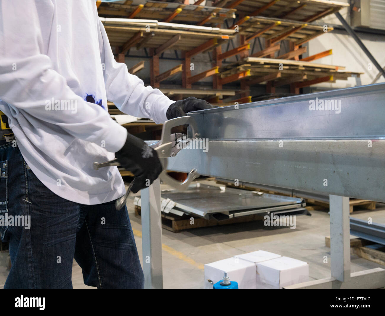 Worker binding metal frames with clamps for welding Stock Photo Alamy