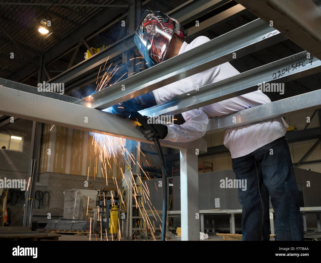 Worker welding metal frames in HVAC manufacturing factory Stock Photo