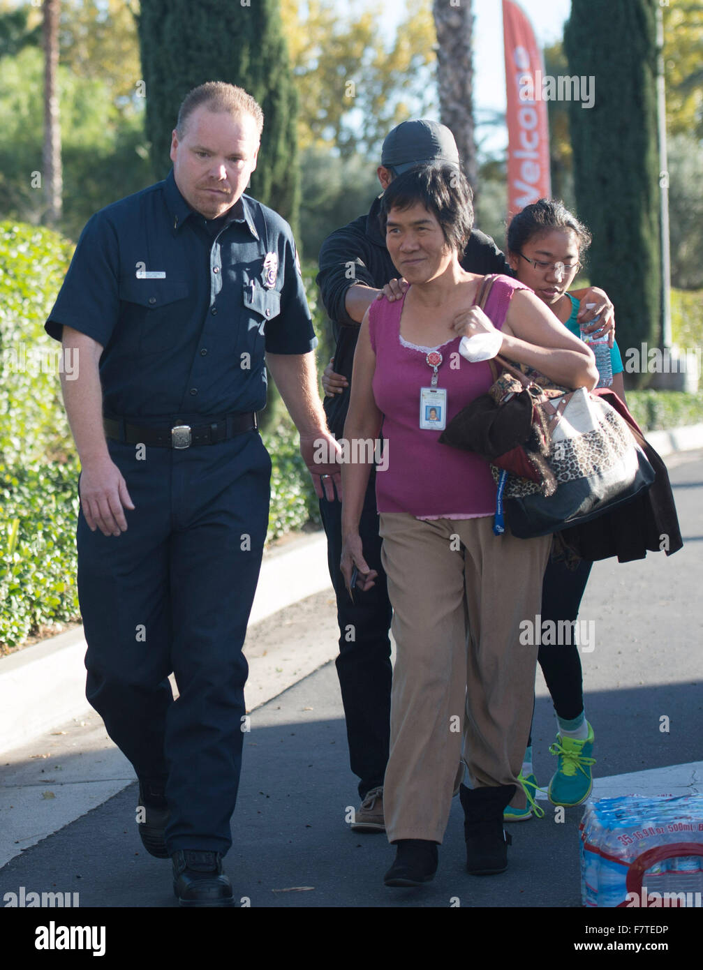Los Angeles, USA. 2nd Dec, 2015. A survivor (R) of the mass shooting at the Inland Regional Center meets her family after police questioning in San Bernardino City of Southern California, the United States, Dec. 2, 2015. One suspect was gunned down and one in custody Wednesday afternoon after a shooting killed at least 14 people and injured 14 others in San Bernardino, local media reported. Credit:  Yang Lei/Xinhua/Alamy Live News Stock Photo