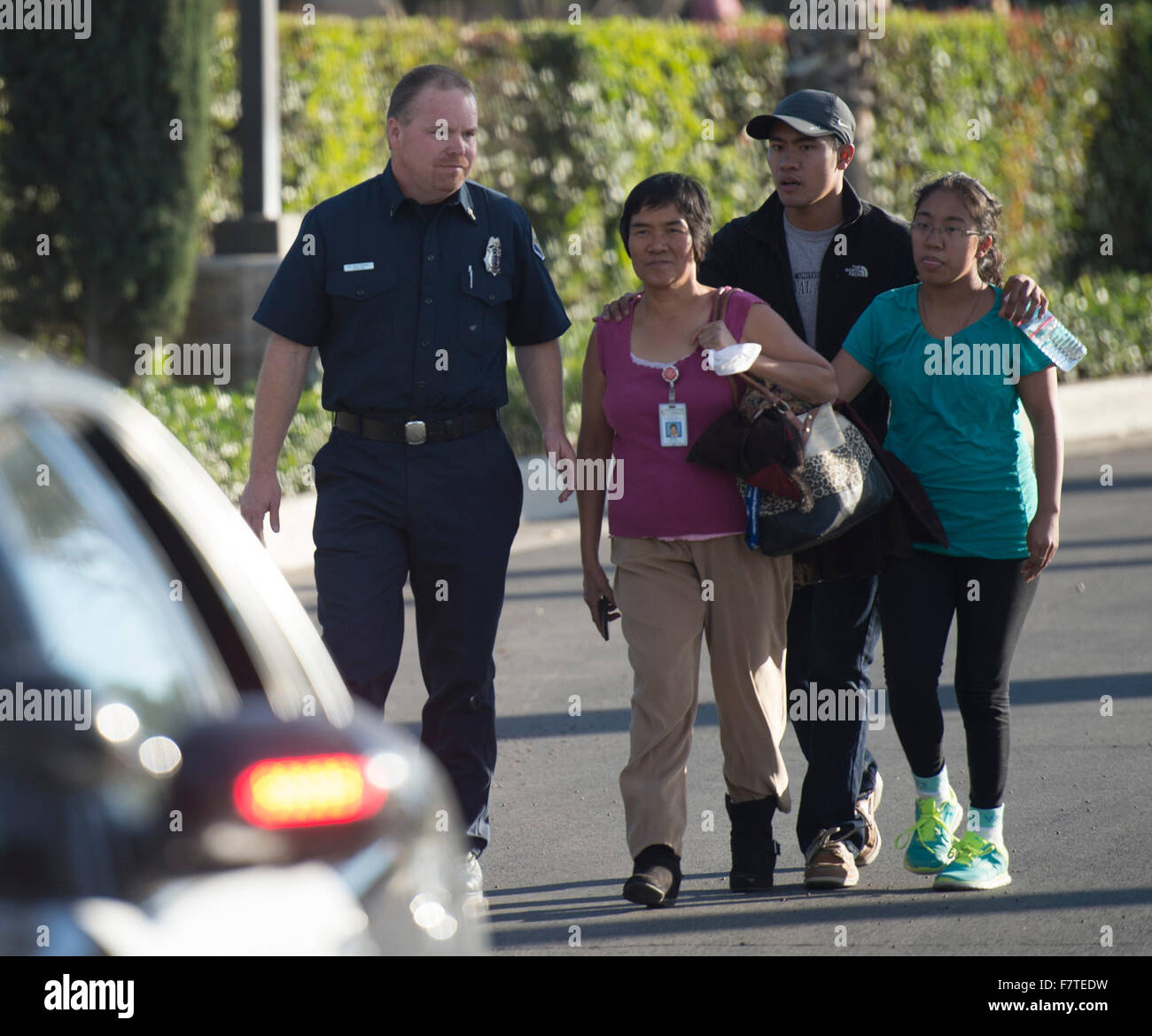 Los Angeles, USA. 2nd Dec, 2015. A survivor (2nd L) of the mass shooting at the Inland Regional Center meets her family after police questioning in San Bernardino City of Southern California, the United States, Dec. 2, 2015. One suspect was gunned down and one in custody Wednesday afternoon after a shooting killed at least 14 people and injured 14 others in San Bernardino, local media reported. Credit:  Yang Lei/Xinhua/Alamy Live News Stock Photo