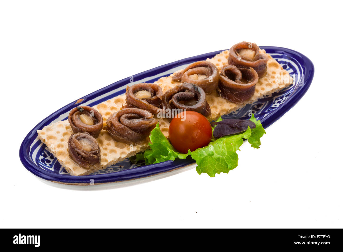 Anchovy snack with salad and tomato Stock Photo