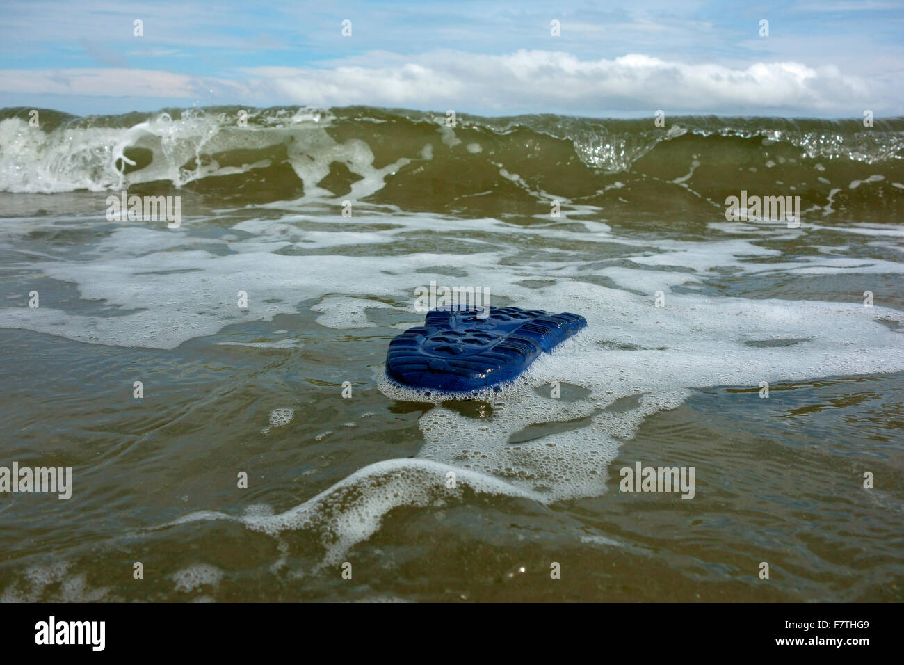 All that remains of a drowning victim at sea is a shoe floating on the surface of the waves Stock Photo
