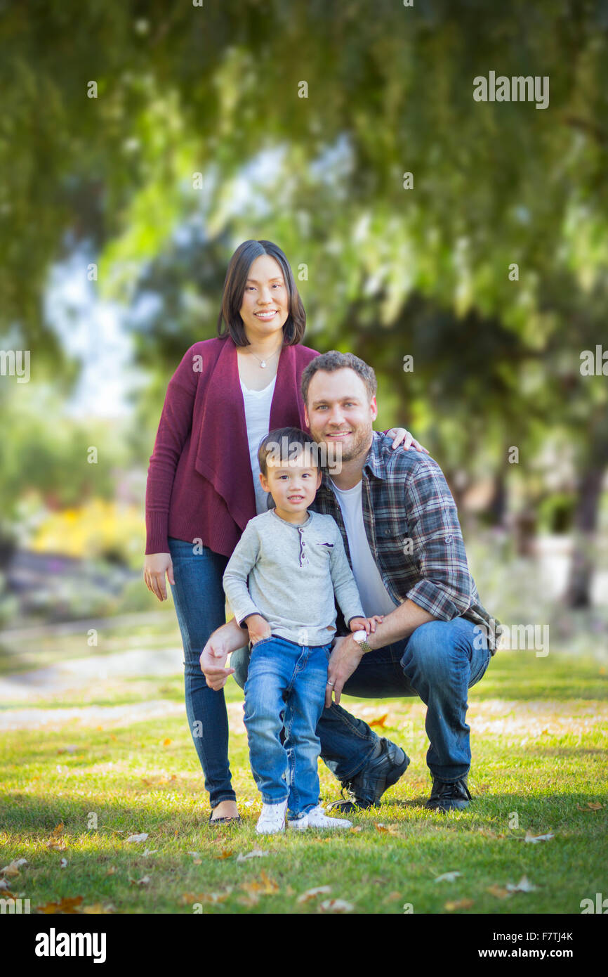 Happy Attractive Mixed Race Young Family Portrait Outdoors. Stock Photo