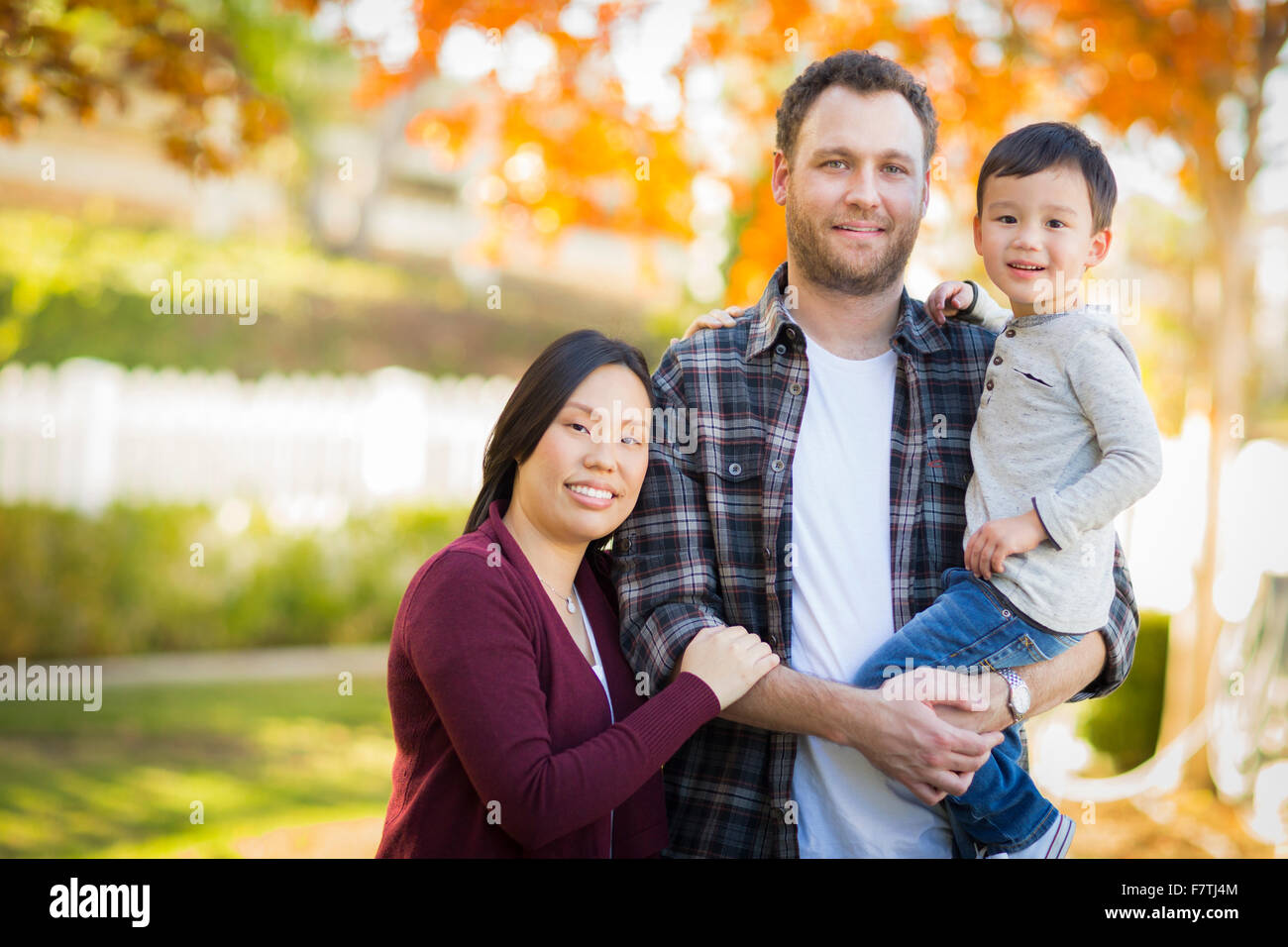 Happy Attractive Mixed Race Young Family Portrait Outdoors. Stock Photo