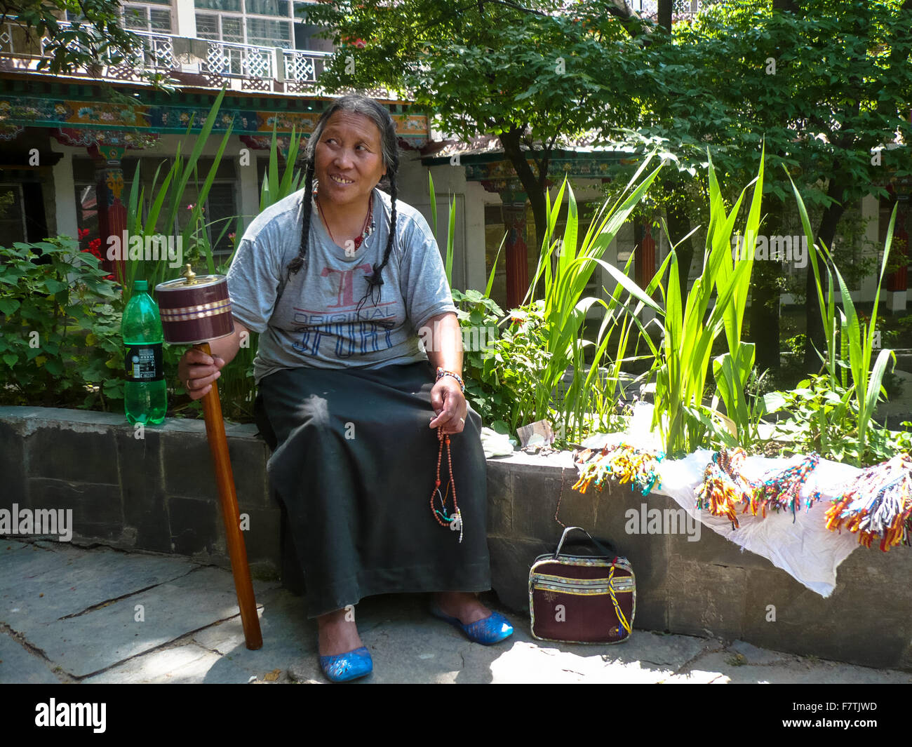 female pelgrim with prayer wheel at dharamsala india Stock Photo