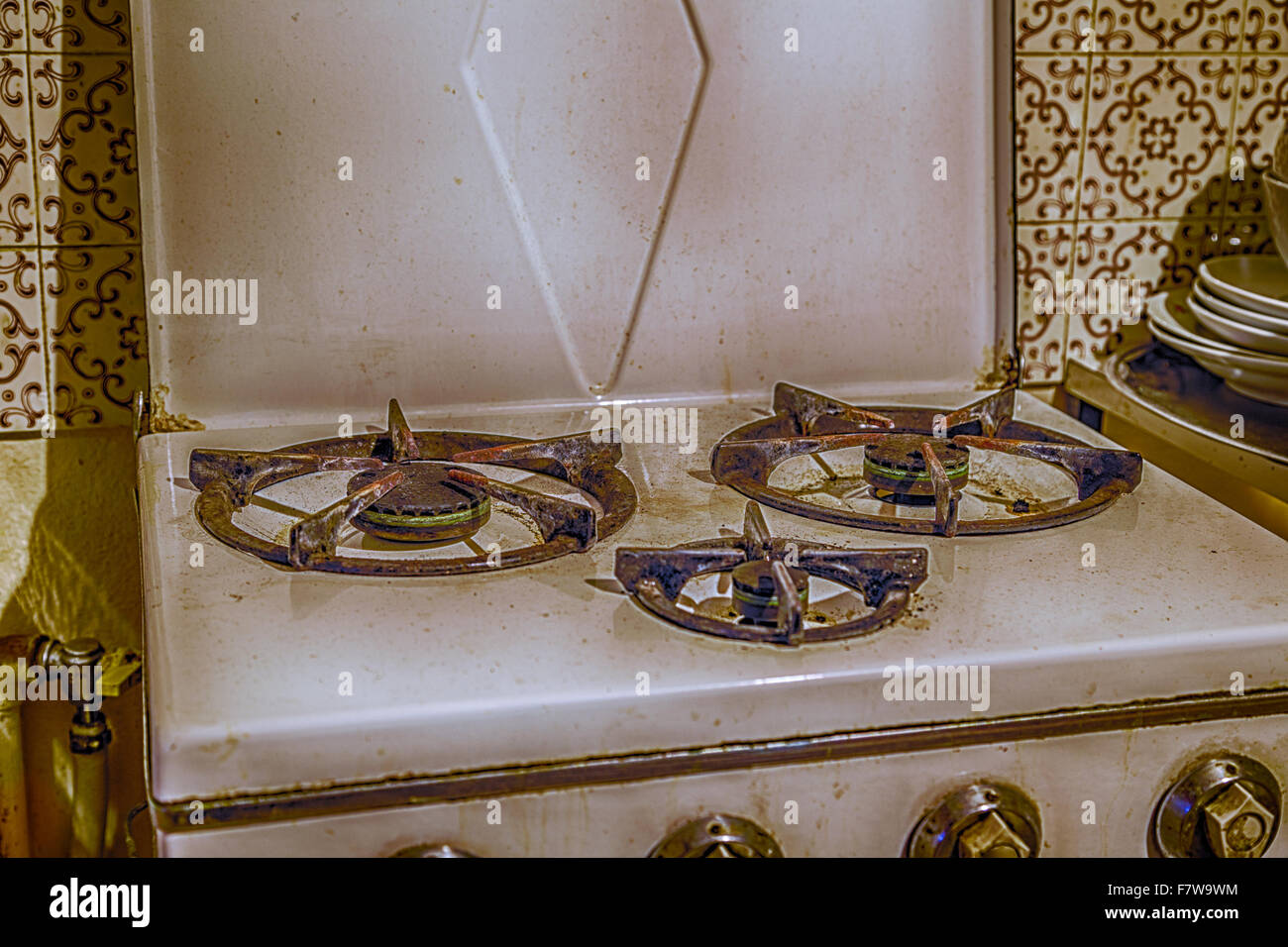 old encrusted gas stove with three burners Stock Photo