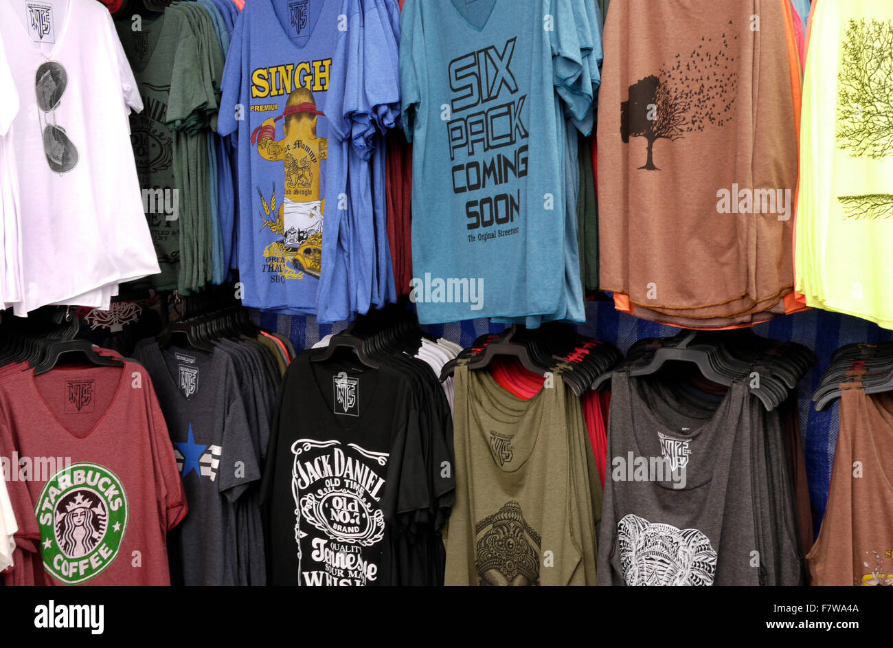 T Shirts for sale on a market stall in Pattaya Thailand Stock Photo