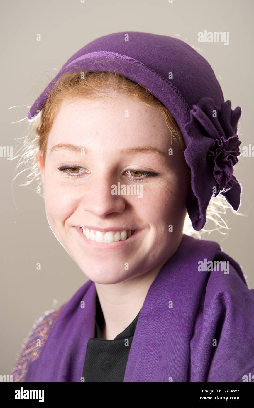 Smiling redhead in purple hat biting lip Stock Photo Alamy