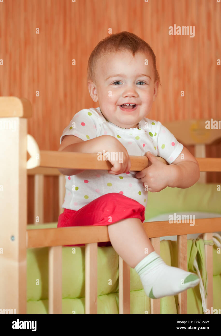 Happy baby of one year old in crib Stock Photo - Alamy
