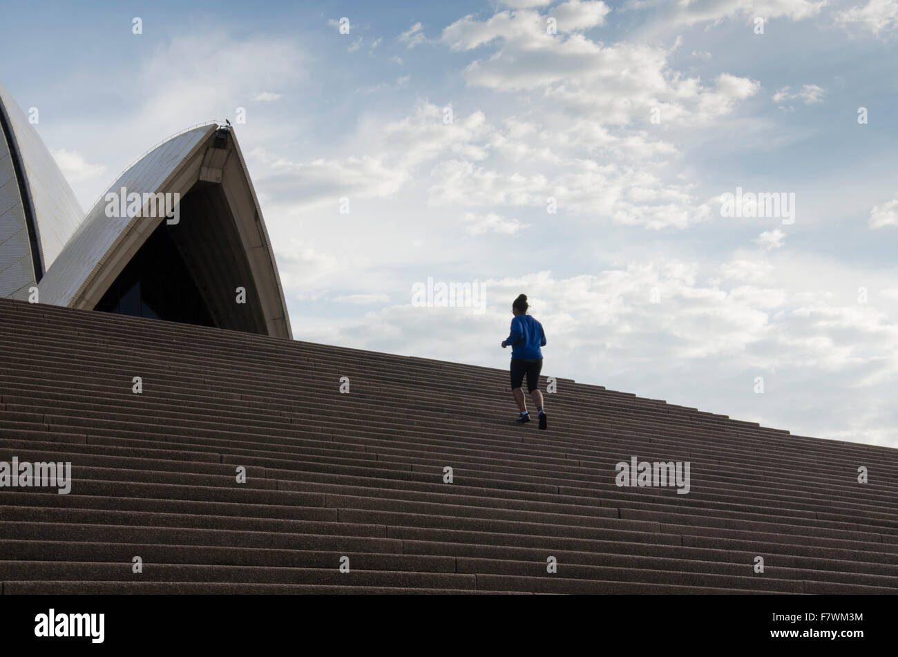 People running through the Royal Botanic Gardens next to Sydney Harbour Stock Photo
