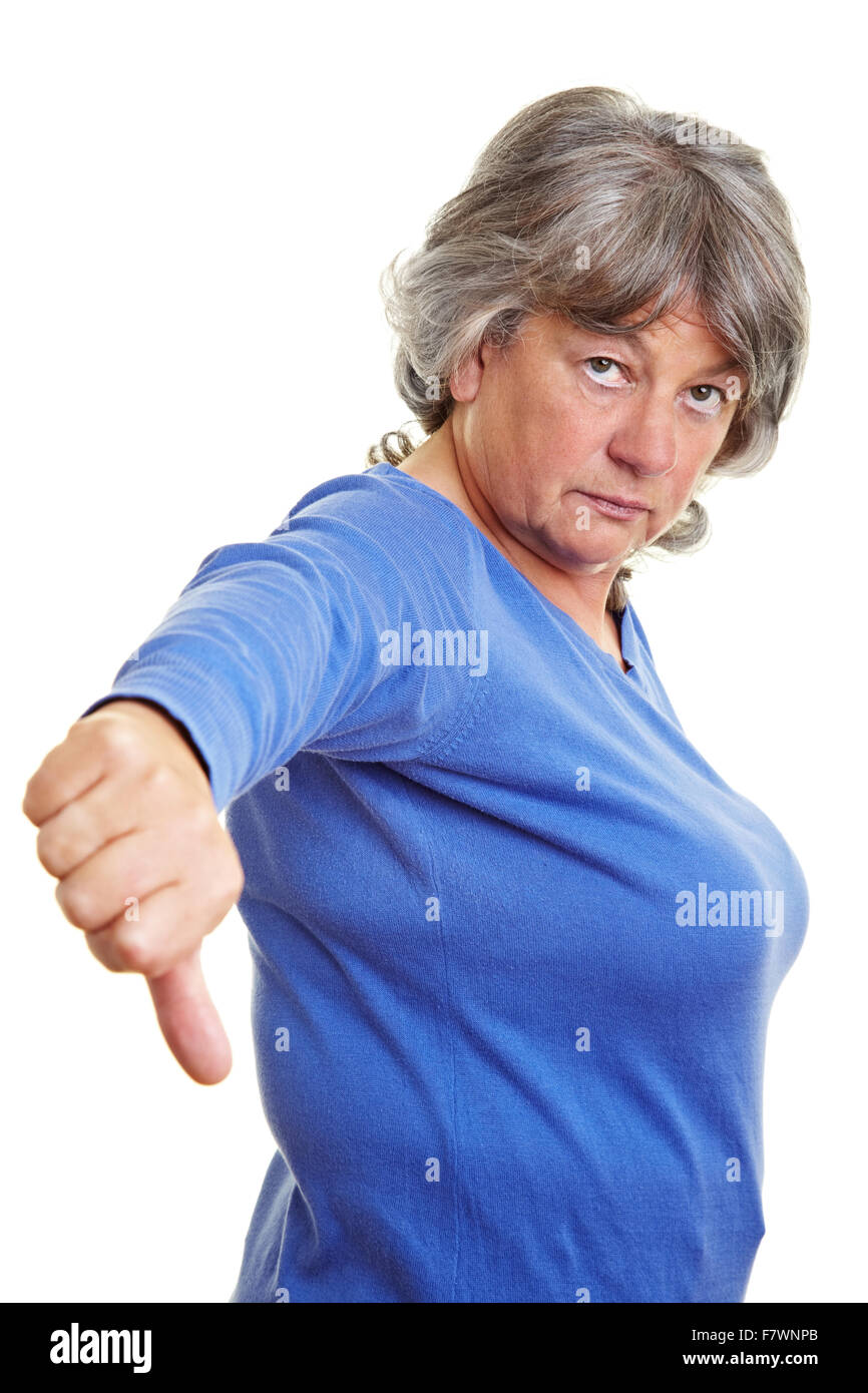 Unhappy pensioner pointing down with her thumb Stock Photo