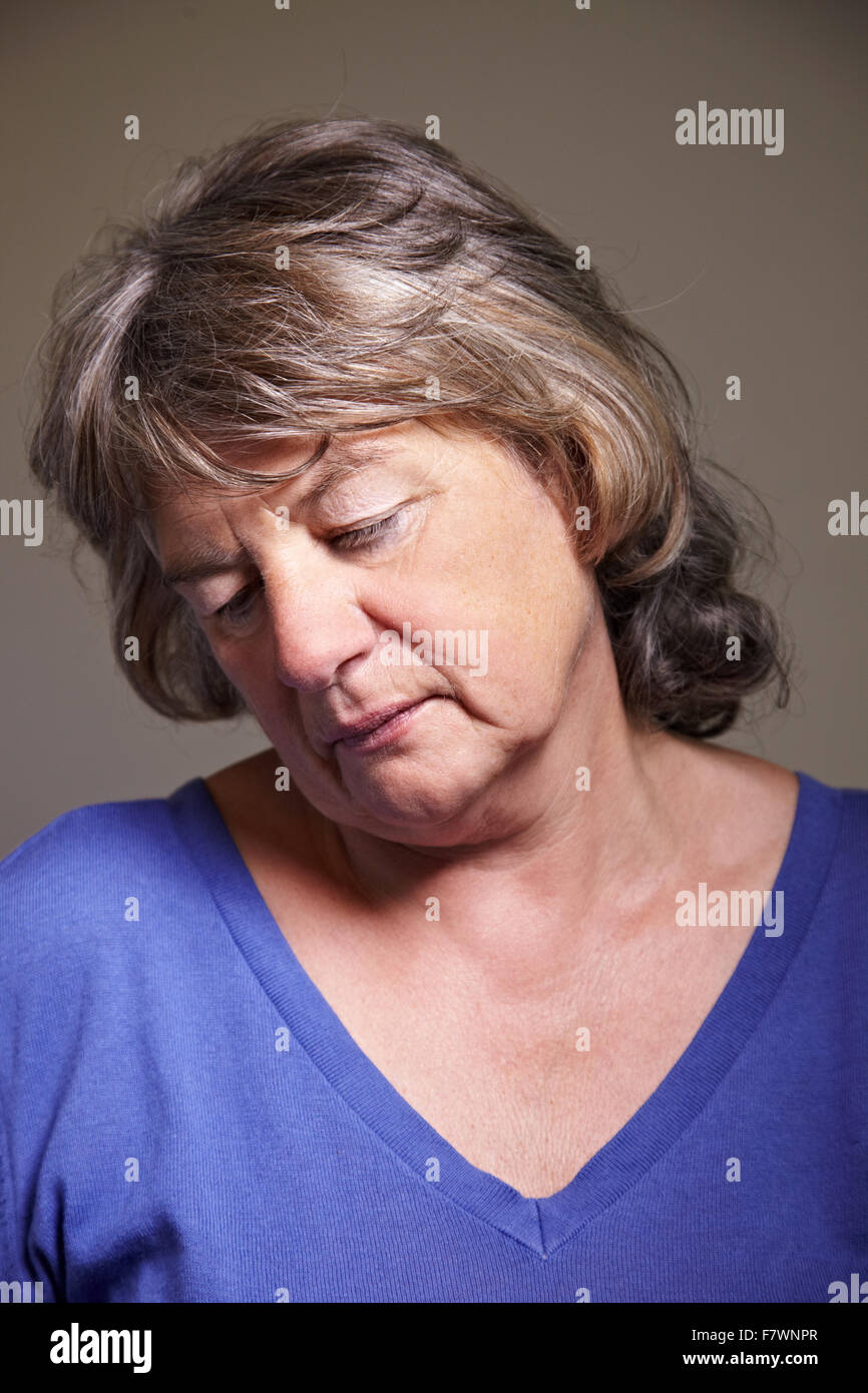 Sad elderly woman looking down with head tilted Stock Photo Alamy