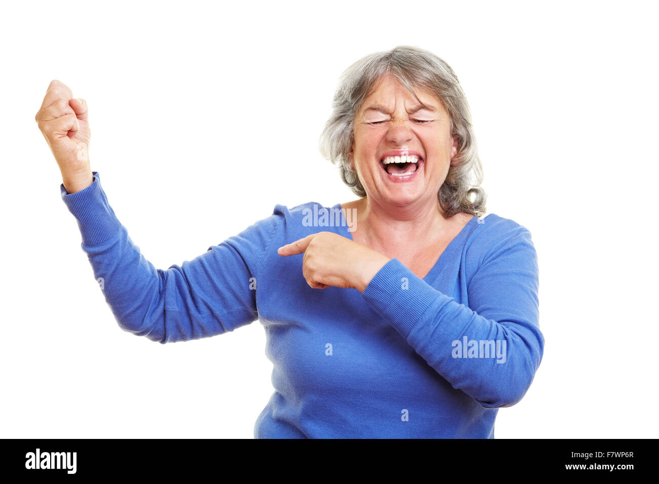 Happy female senior citizen showing her muscles Stock Photo