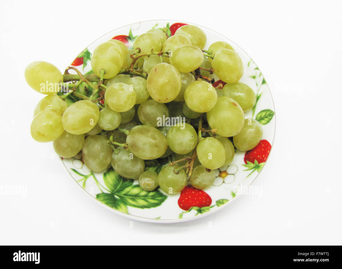 Grape on plate is insulated on light background Stock Photo