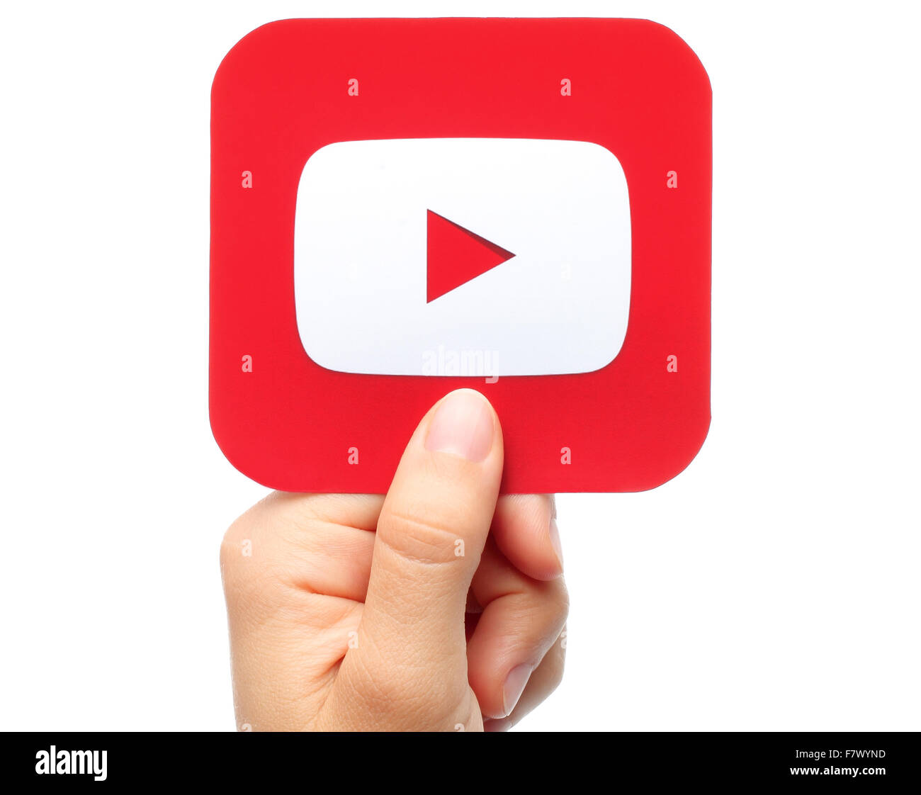 Kiev, Ukraine - August 18, 2015:Hand holds YouTube icon printed on paper on white background. YouTube is a video-sharing website Stock Photo