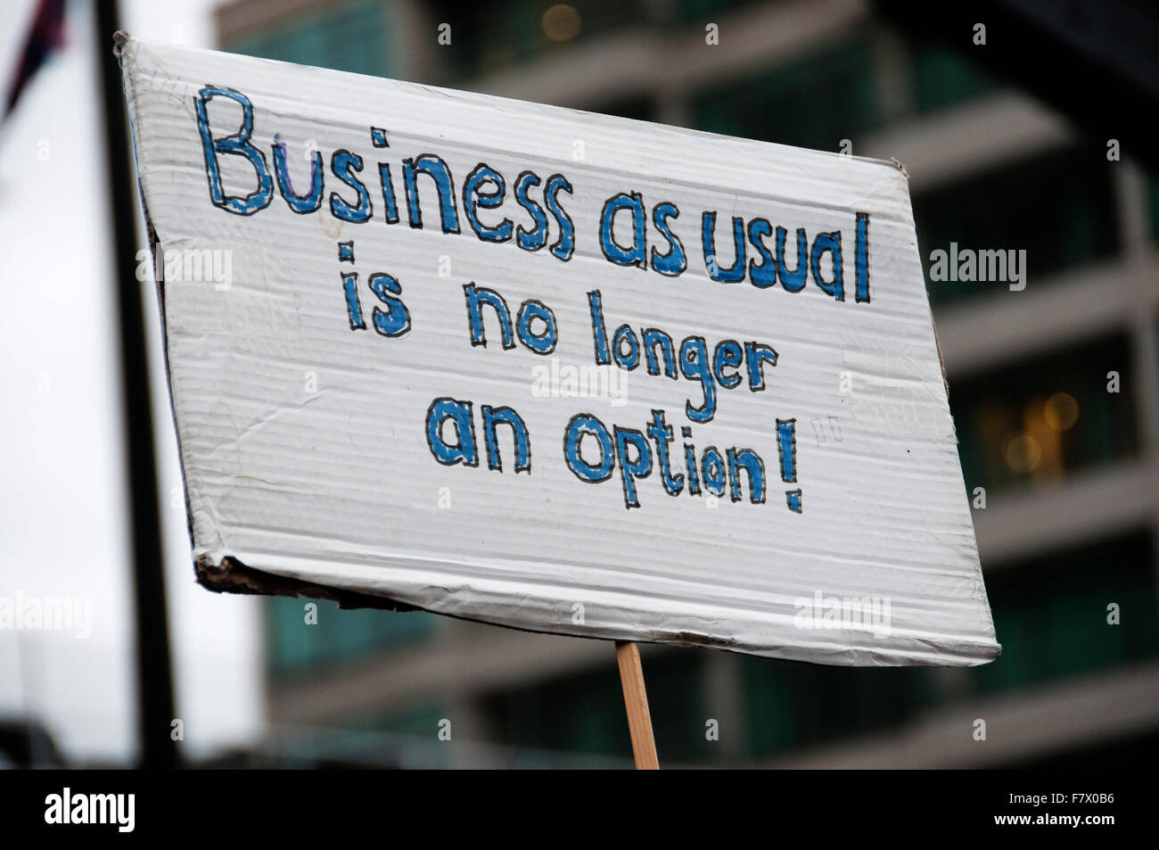 March to demand global leaders take action to combat Climate Change. Sign saying 'Business as usual is no longer an option'. Stock Photo