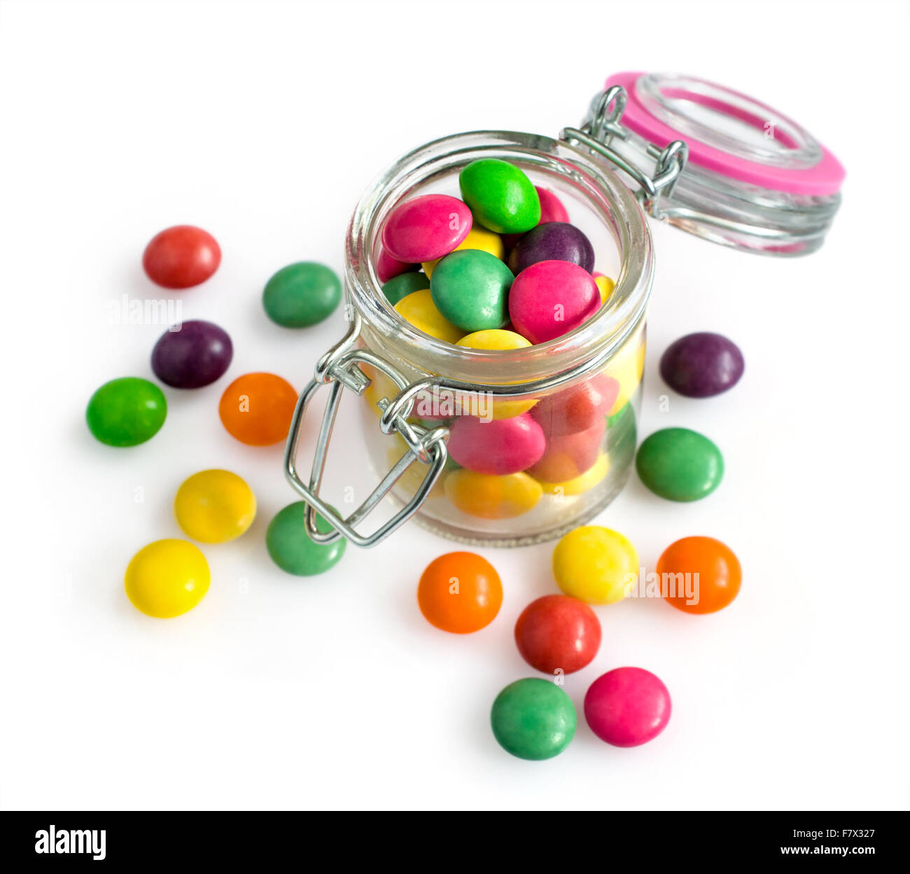 Colorful candy drops in a glass jar isolated over white Stock Photo