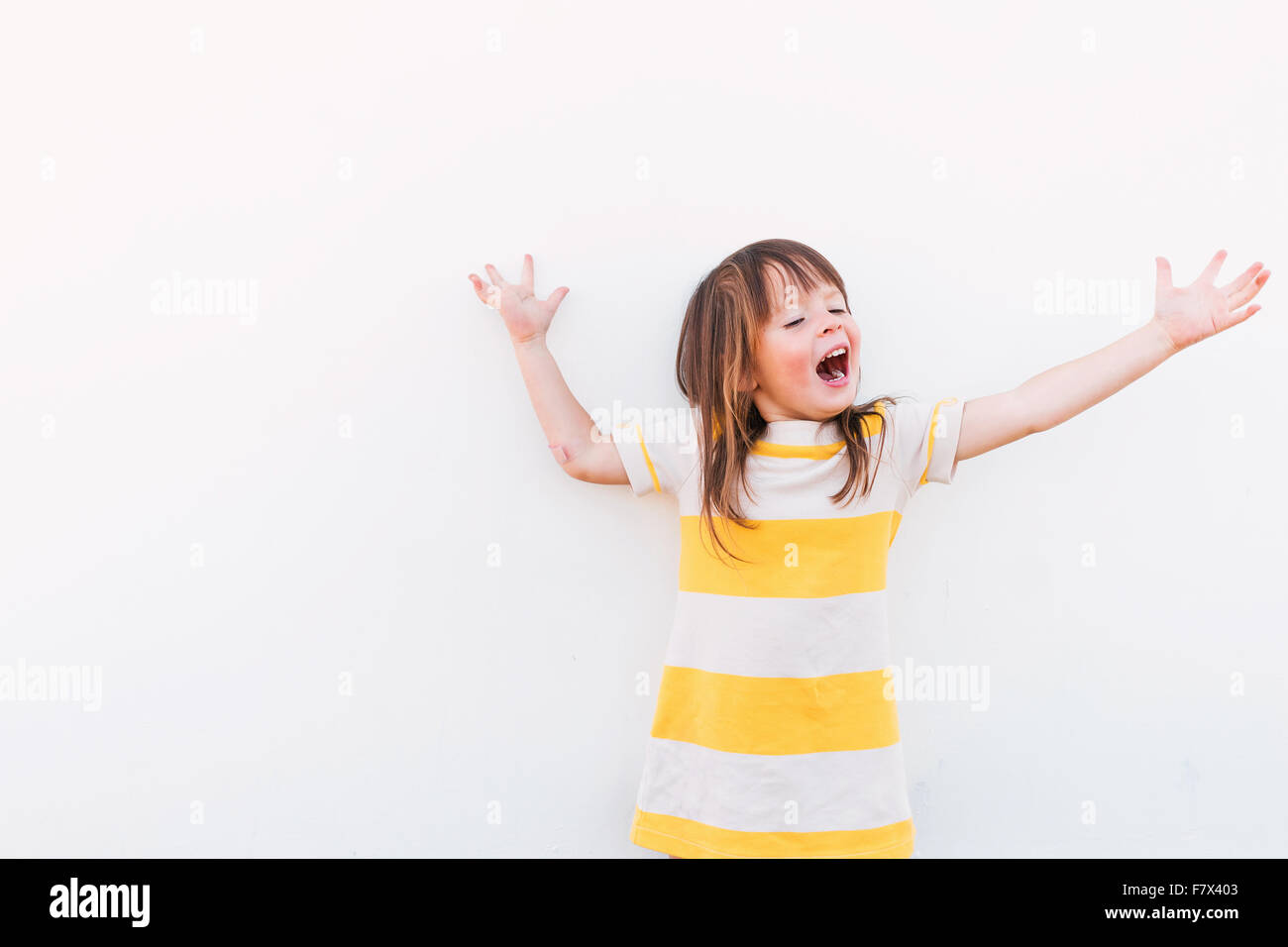 Smiling girl with outstretched arms Stock Photo