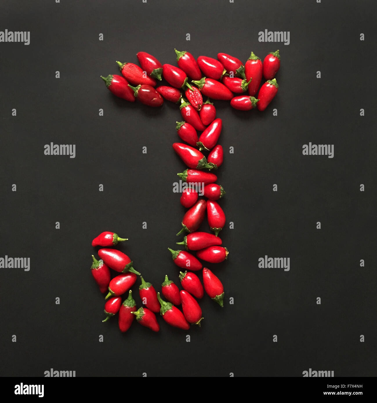 Letter J made from jalapeno peppers Stock Photo