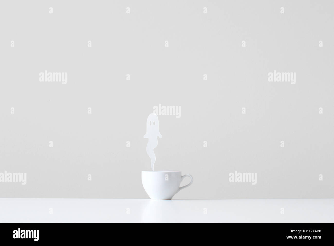 Conceptual cup with ghost steam rising Stock Photo