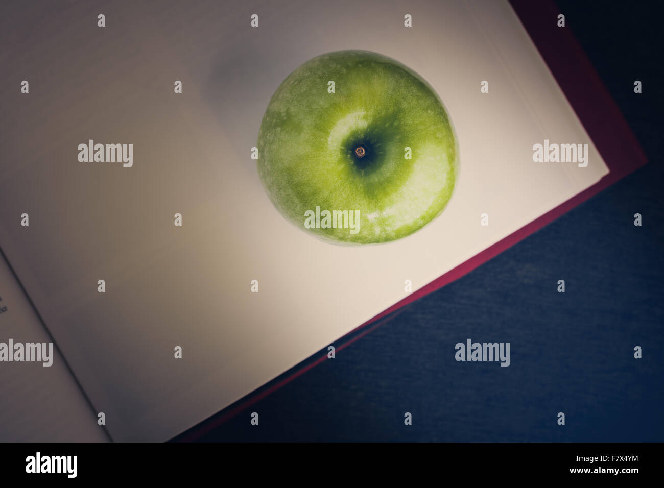 Green apple with book illustrated knowledge and wisdom concept. Stock Photo