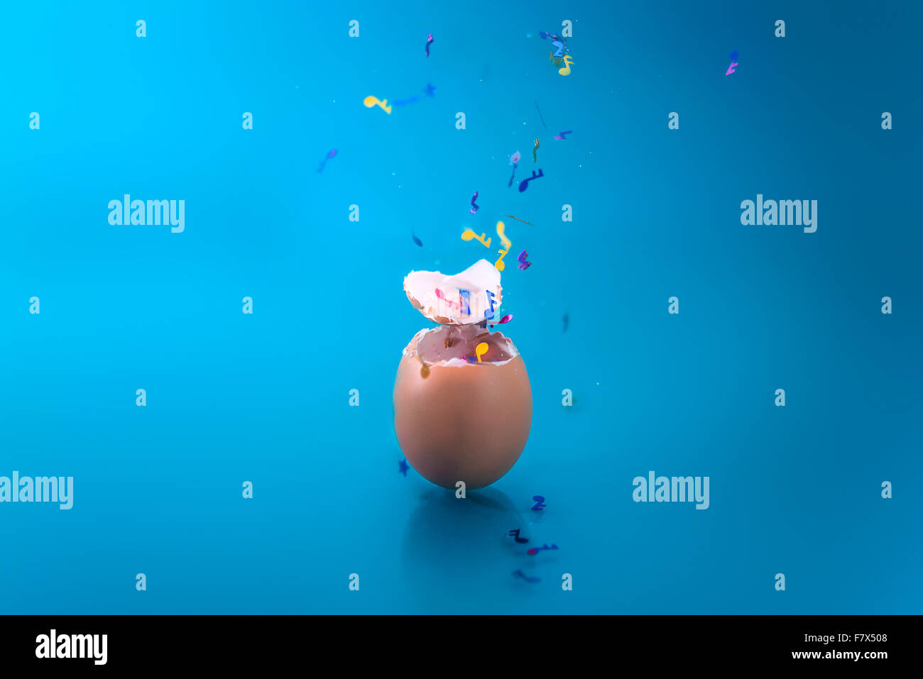 Musical confetti bursting out of an egg Stock Photo