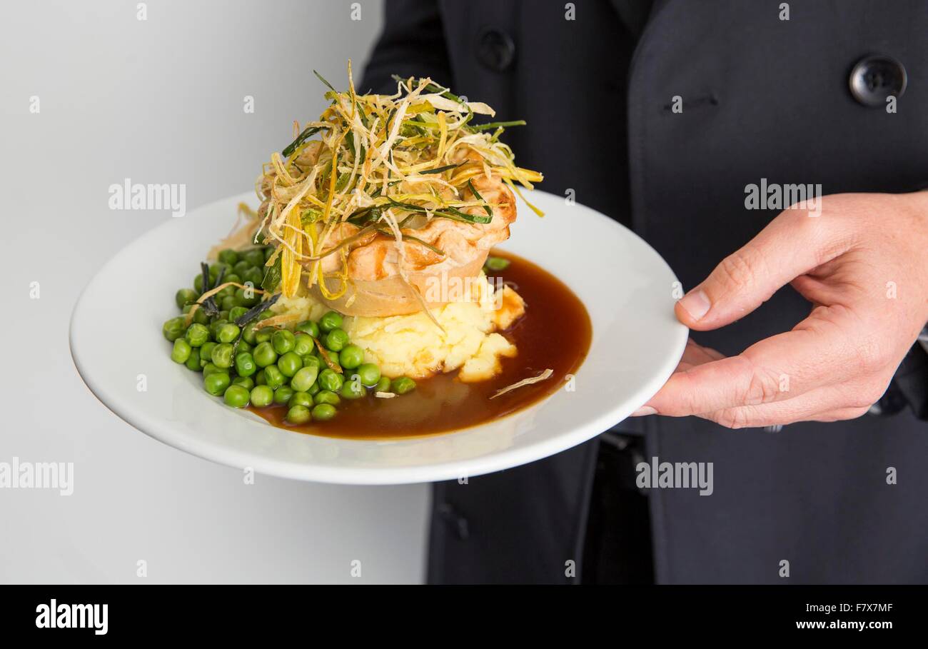 Nailsworth, Gloucestershire, UK. 3rd Dec, 2015. Jay Weatherill poses with a vegan pie at Forest Green Rovers FC, Stroud. Ecotricity boss Dale Vince welcomed a special delegation from South Australia led by Premier Jay Weatherill, to Forest Green FC today. Weatherill announced that Adelaide is to become the world's first carbon neutral city. The Premier met Vince on a fact finding mission to discuss the future of renewable technology and climate control, before travelling onto to meet UN Secretary General Ban Ki-moon at the Paris Climate Change Summit. © Adam Gasson/Alamy Live N Stock Photo