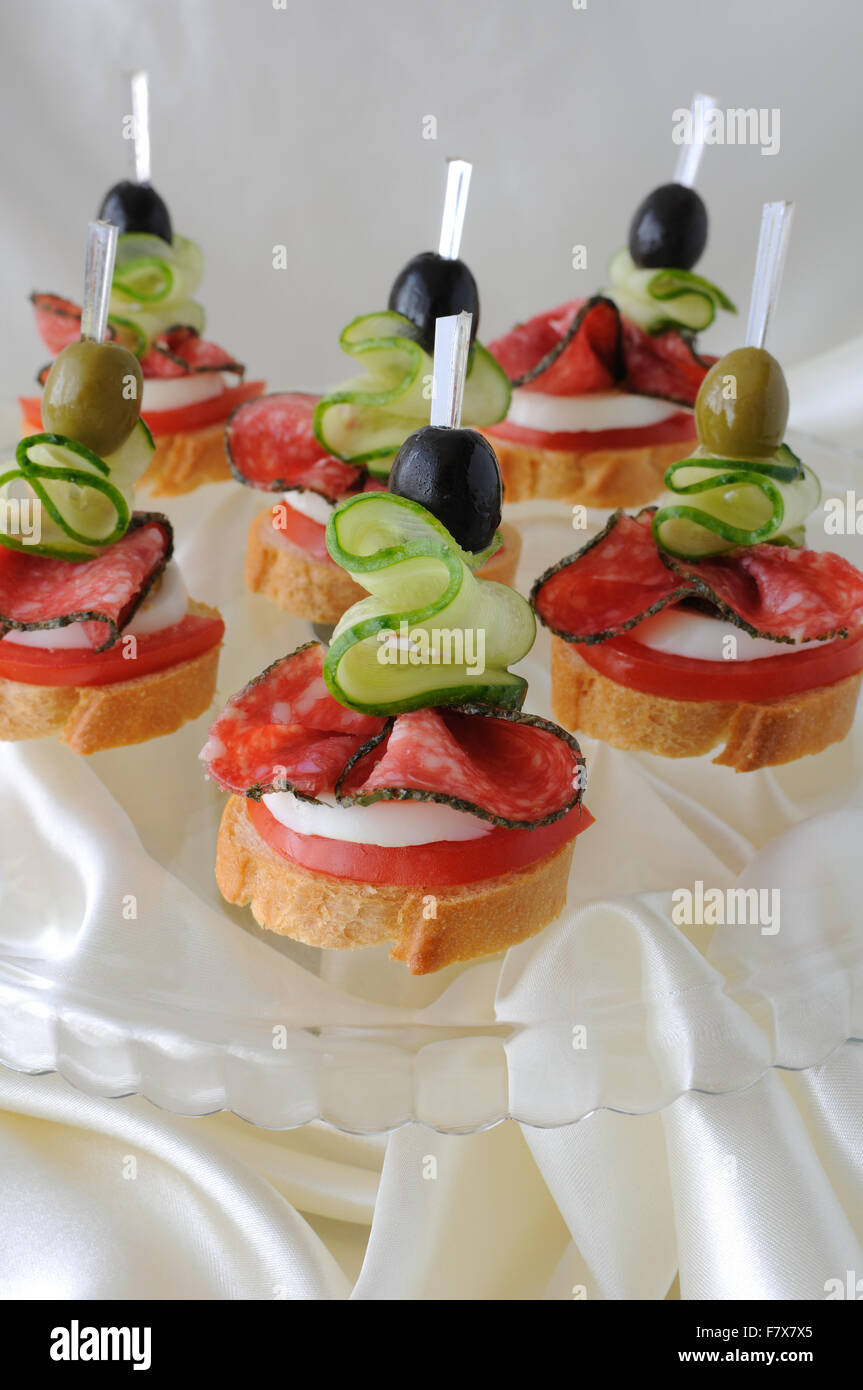 Canape of the baguette with salami on a glass base Stock Photo - Alamy