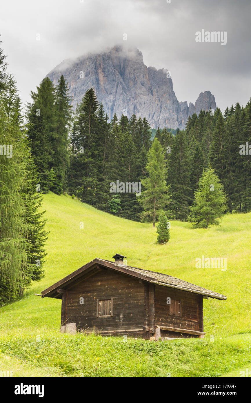 Mount Langkofel in the Sassolungo mountain range with a small cabine in  front, clouds covering the top, Selva, Val Gardena, Ital Stock Photo - Alamy