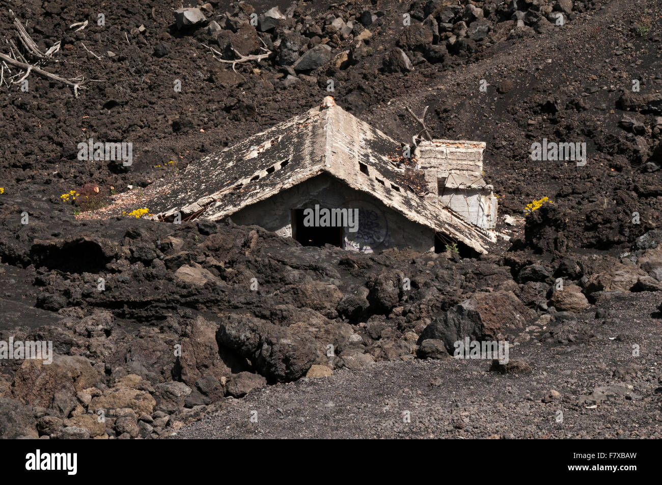 3300 meter high Mount Etna on the east coast of Sicily buried this house in 1987 in one of its lava flows. Stock Photo