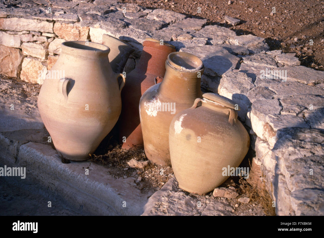 Replicas of traditional Biblical Jewish pots leaning against stone wall