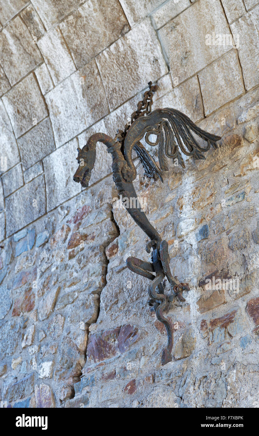 LJUBLJANA, SLOVENIA - SEPTEMBER 06, 2015: Steel gorgeous medieval mascot dragon in the form of a torch holder on the wall in the Stock Photo