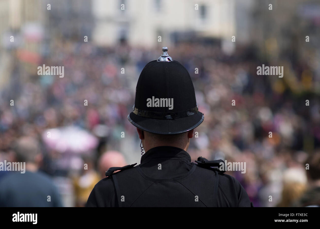 Police officer watches the crowds in Truro Cornwall Stock Photo