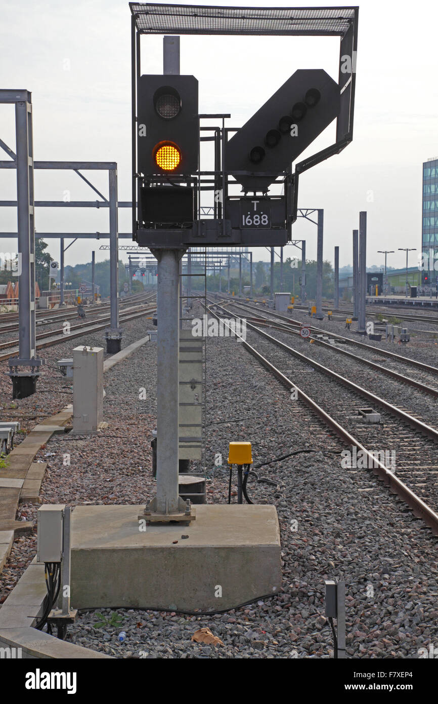 A new LED train signal displaying a yellow proceed aspect along the side of  a Railway track with identification number plate Stock Photo - Alamy