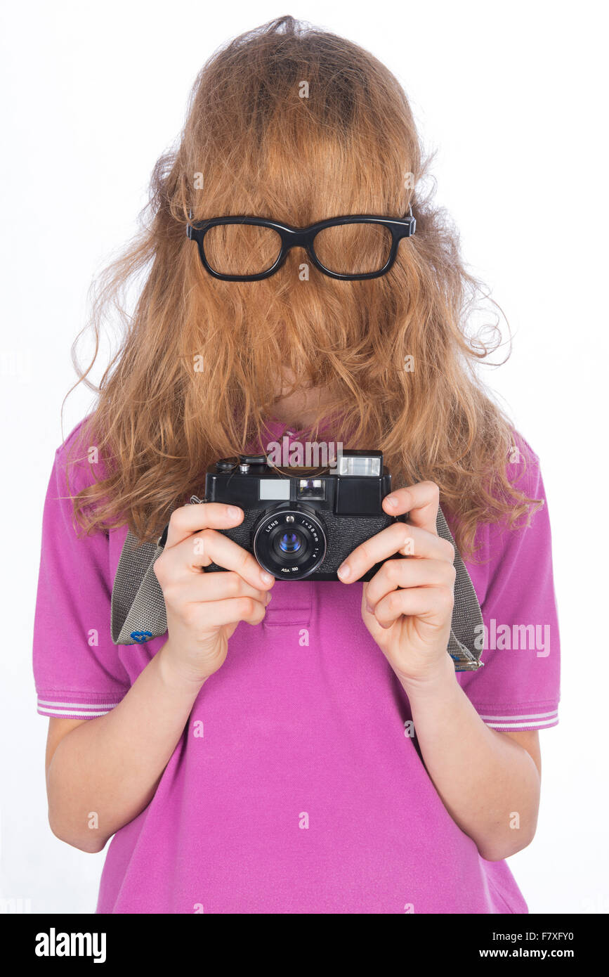 Young photographer like Hit cousin, his face covered with long hair Stock Photo