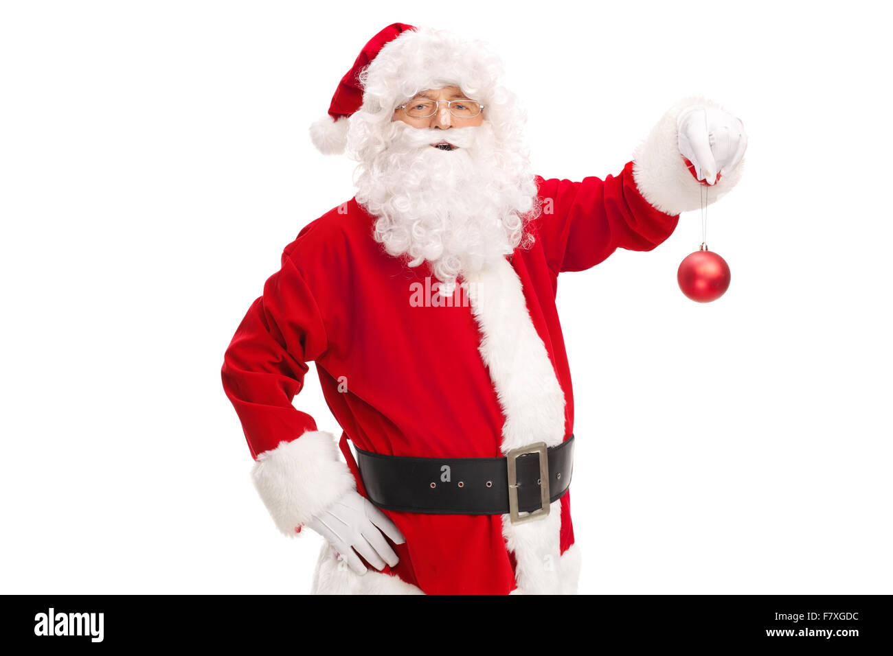 Studio shot of Santa Claus holding a red Christmas ball and looking at the camera isolated on white background Stock Photo