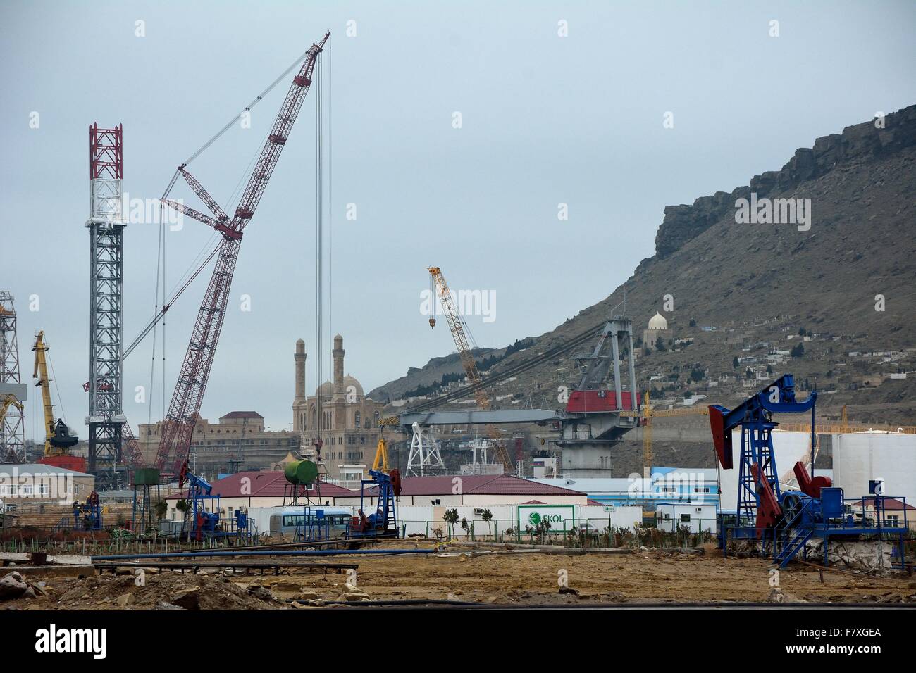 Docks near Baku with Bibiheybat Mosque in background, wide shot with oil pump in foreground Stock Photo