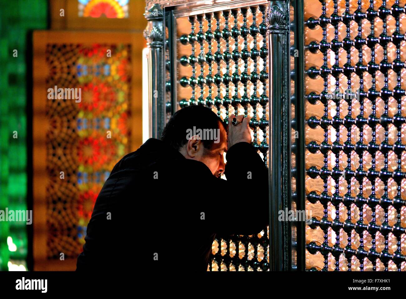 Man praying against the tomb of Ukeyma Khanum in Bibi-heybat Mosque, just outside Baku, capital of Azerbaijan Stock Photo