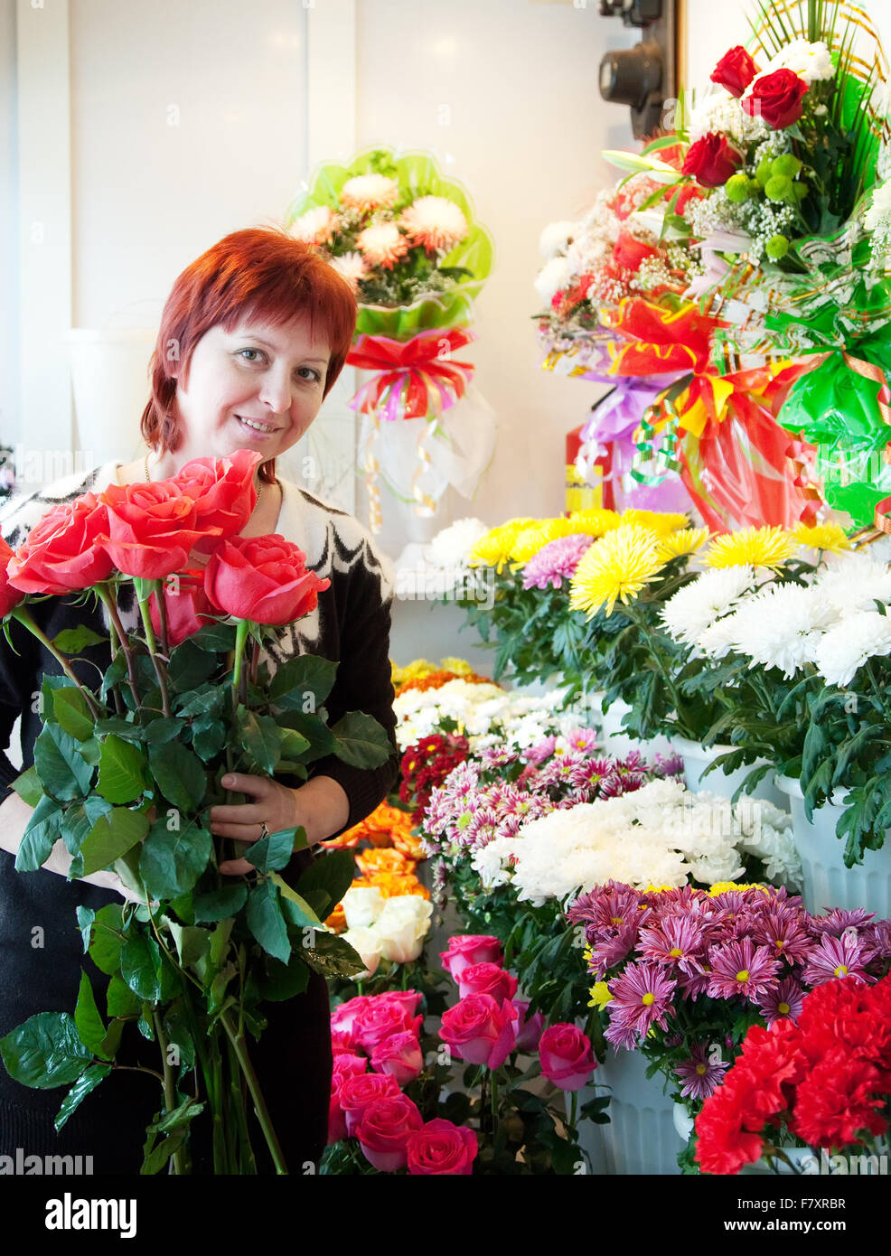Middle-aged woman in flower shop Stock Photo - Alamy