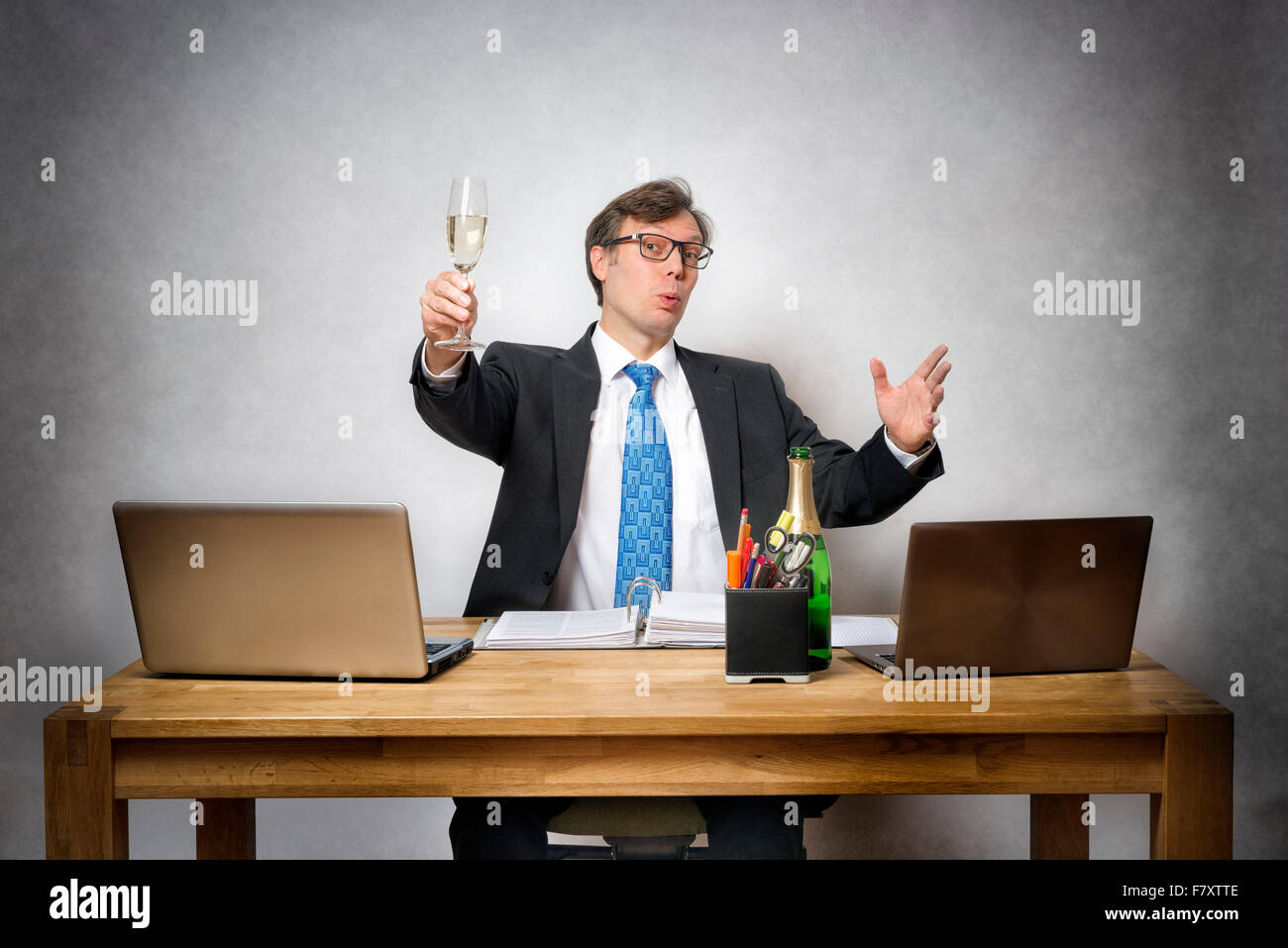 Image of happy business man with champagne glass in office Stock Photo