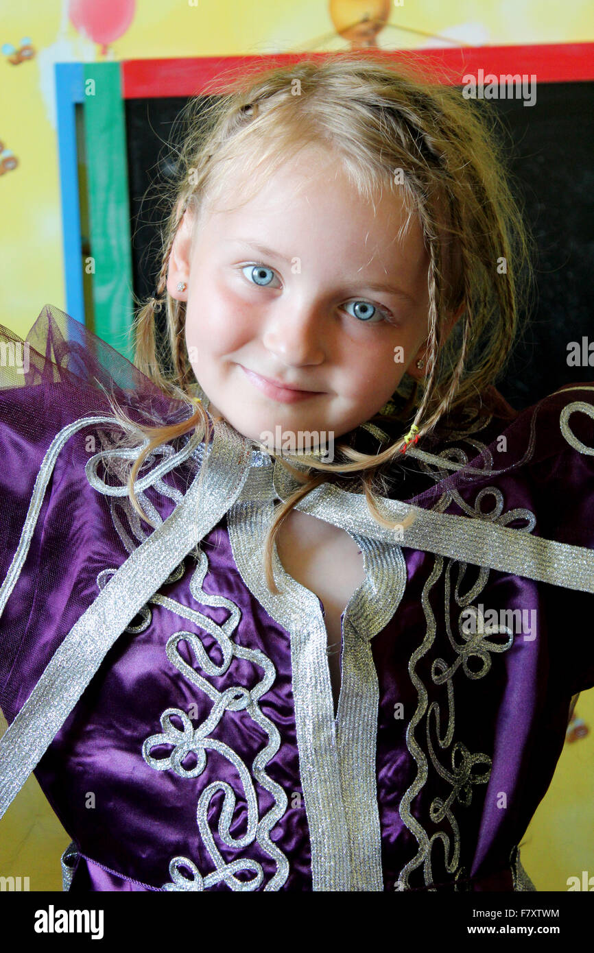 little blue-eyed sympathetic girl in an Moroccan suit Stock Photo