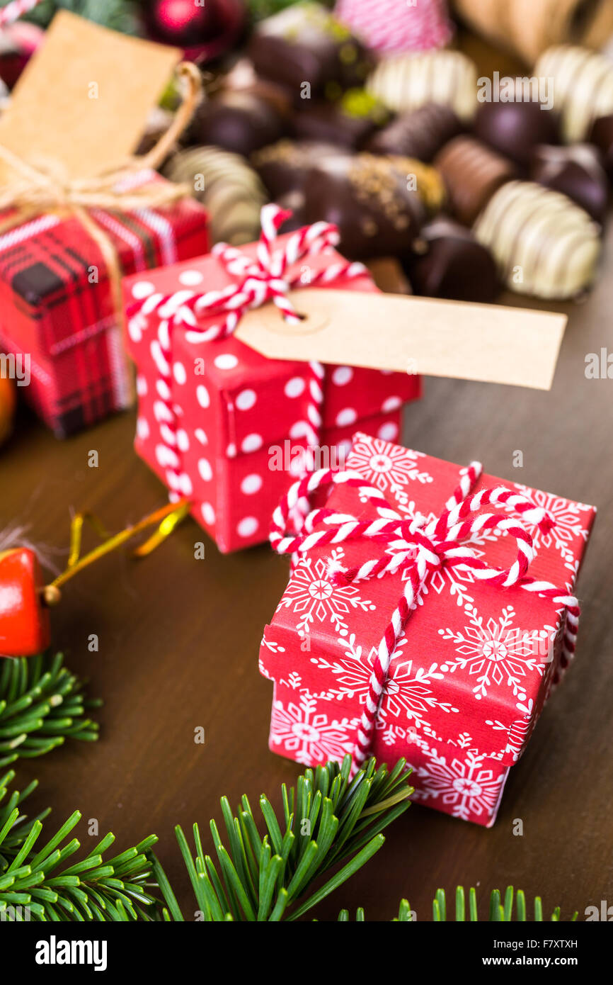 Wrapping assorted chocolates in small boxes for Christmas presents