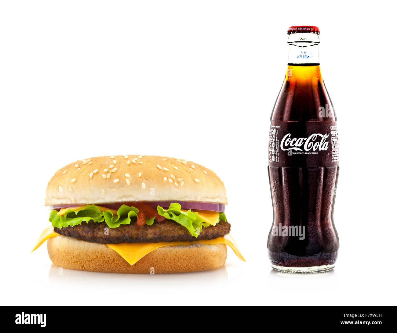 Big Hamburger with a Bottle of Cold Coca-Cola on a White Background Stock Photo