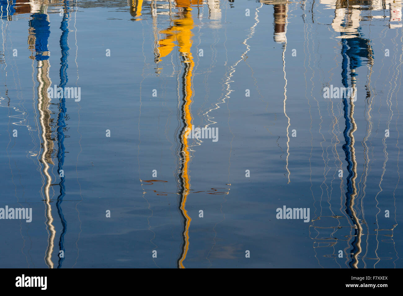 Reflections of sailboat masts in water in Bayfield Wisconsin on Lake Superior Stock Photo