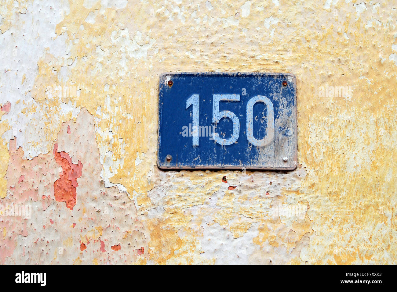 House address plate number (150) hanging on wall Stock Photo